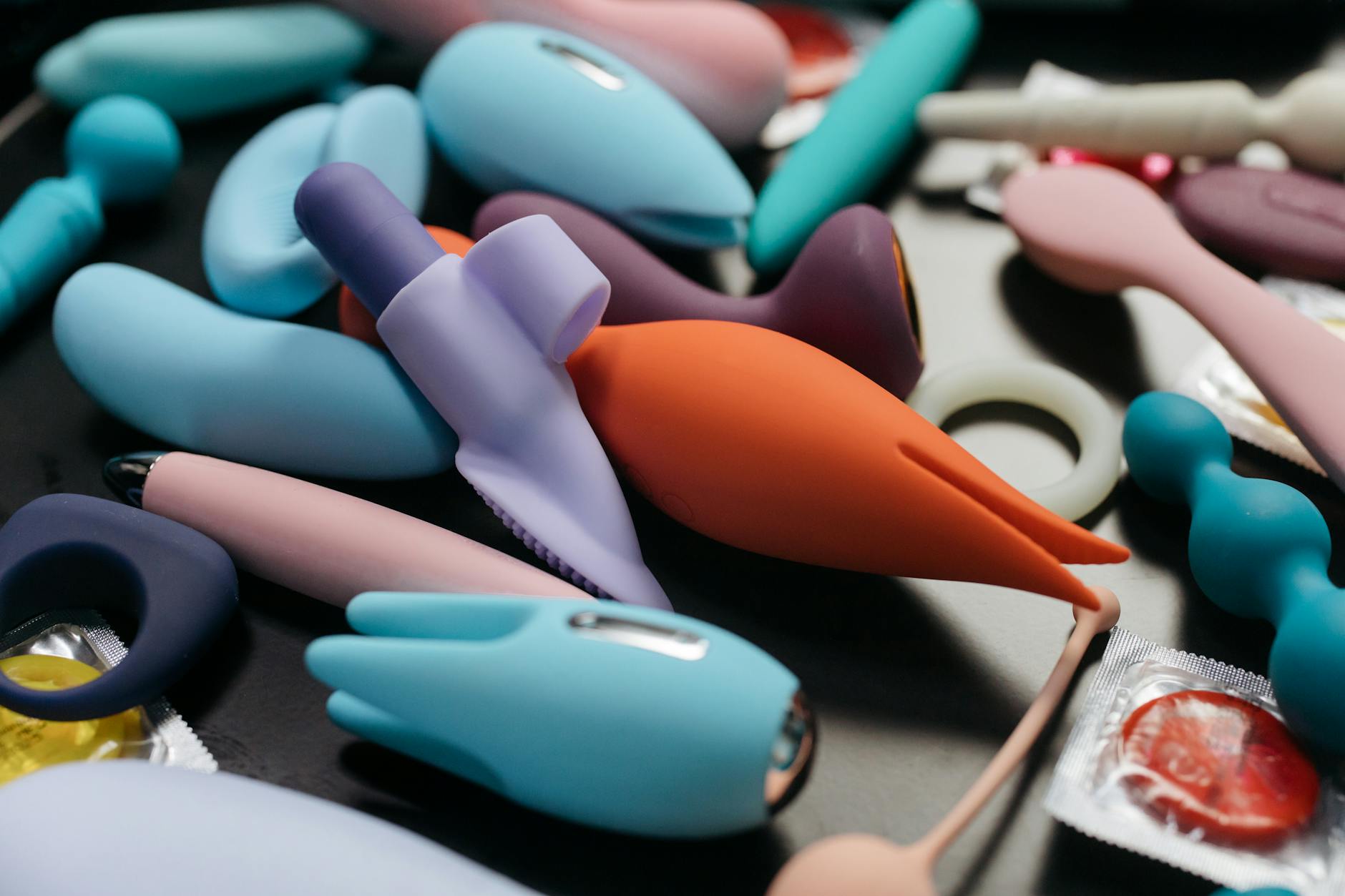 Array of colorful vibrators and intimate wellness toys in close-up view