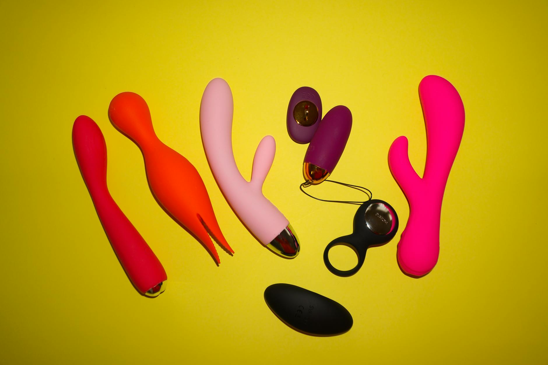 Hands holding a gentle vibrator against soft fabric, symbolizing tender self-care during recovery