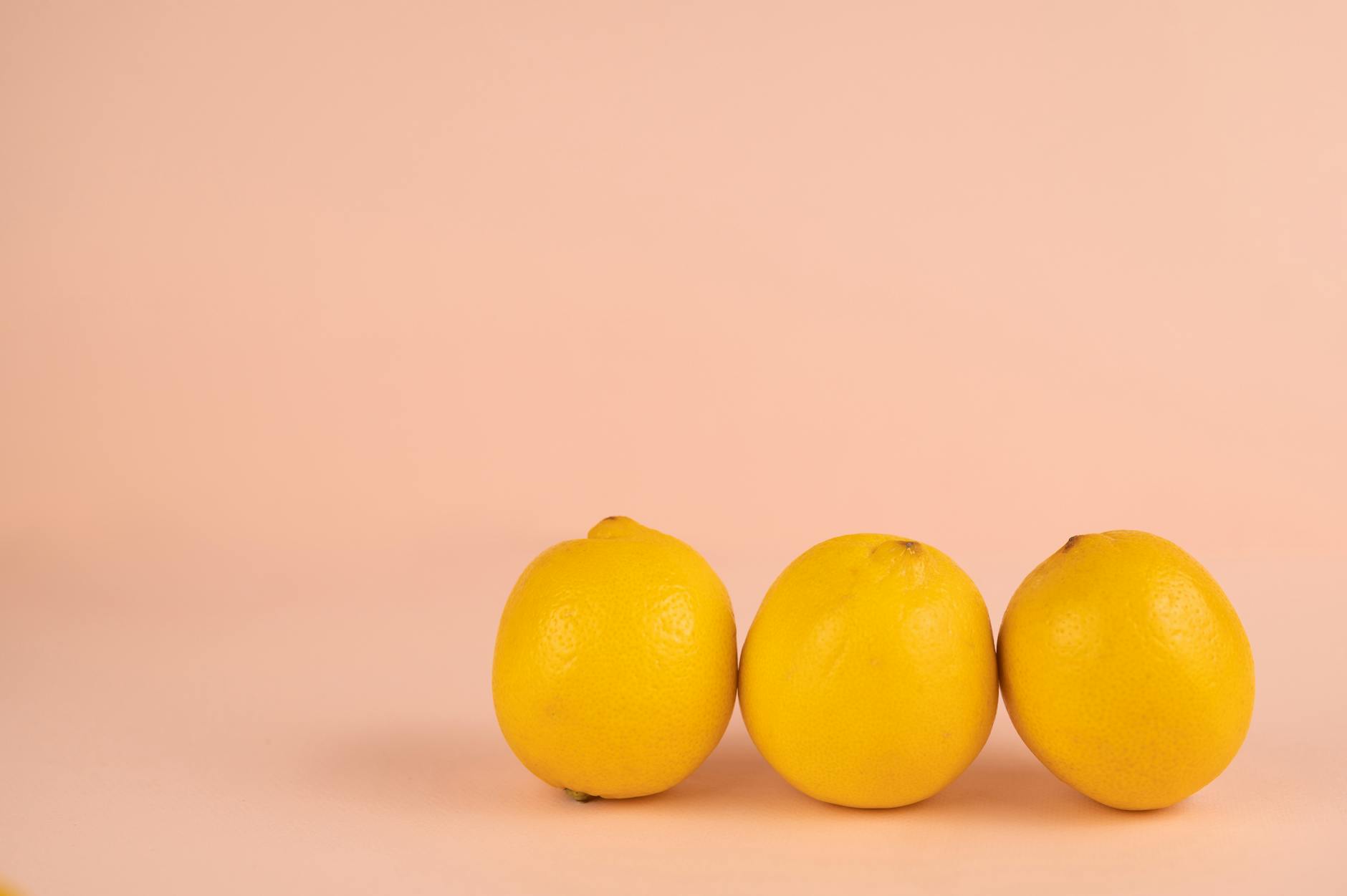 Bright ripe lemons arranged on a pastel background, symbolizing freshness and vitality