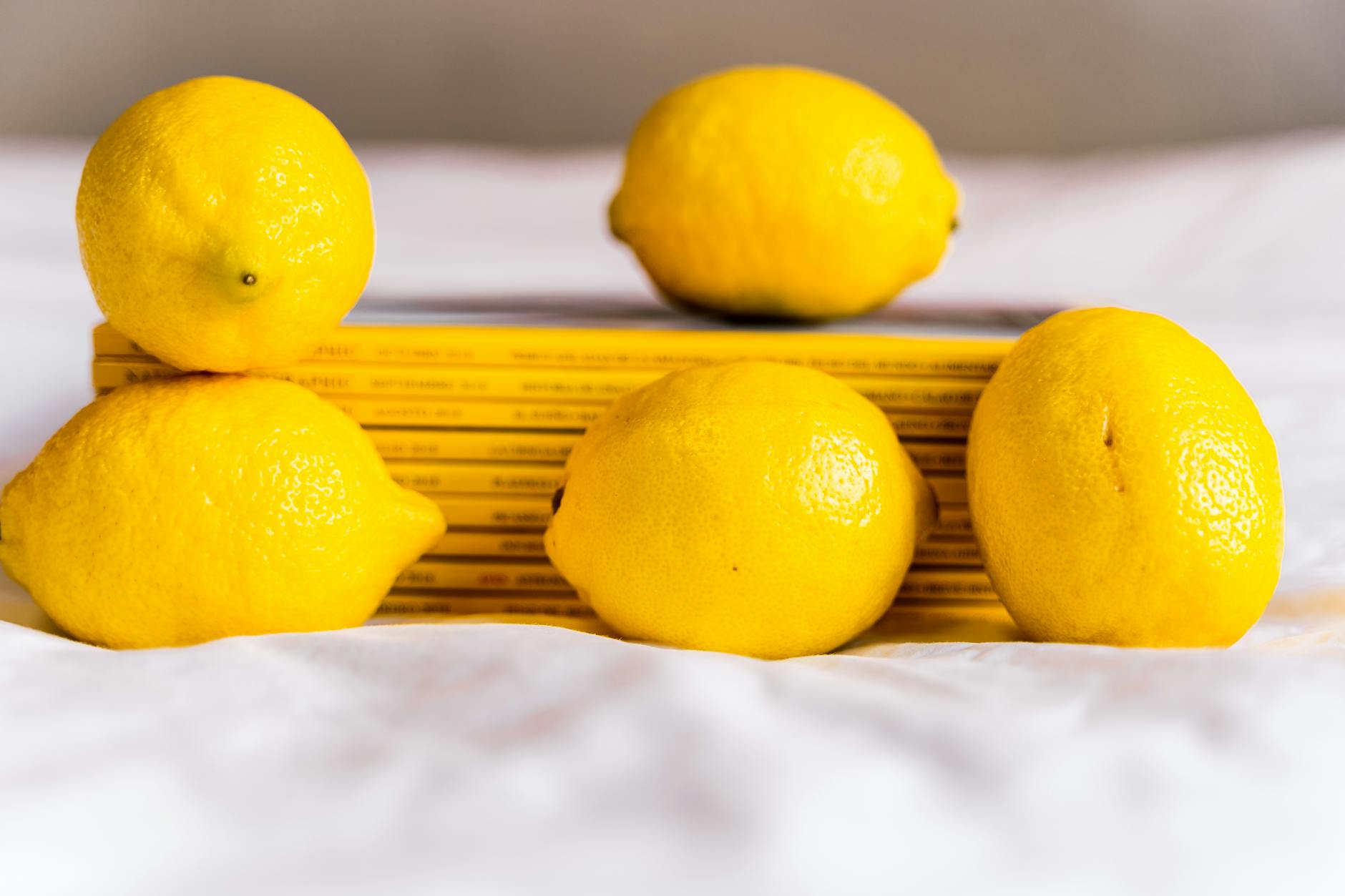 Lemons arranged with books on white tablecloth symbolizing intentional, mindful connection